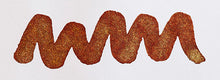 Load image into Gallery viewer, A colour swatch of Diamine Brandy Dazzle shimmering fountain pen ink.
