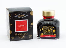 Load image into Gallery viewer, A glass bottle of 80ml Diamine Matador fountain pen ink next to its packaging box, in front of a white background.
